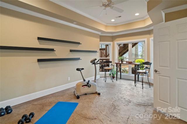 workout area featuring crown molding, baseboards, recessed lighting, a ceiling fan, and a tray ceiling