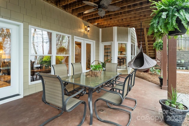 view of patio with fence, ceiling fan, and outdoor dining space
