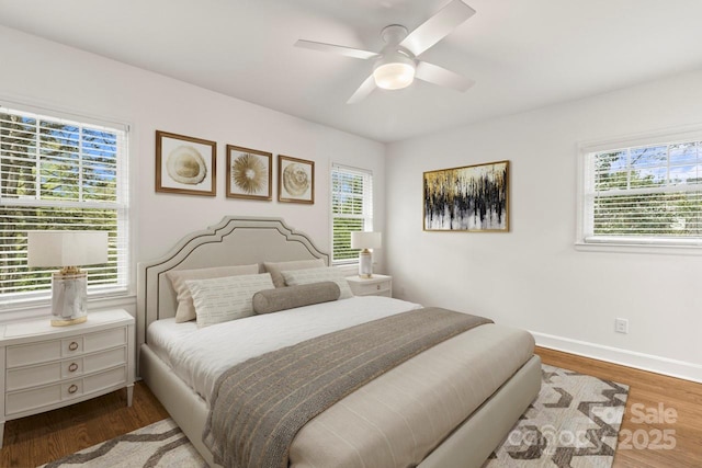 bedroom with wood finished floors, baseboards, and a ceiling fan