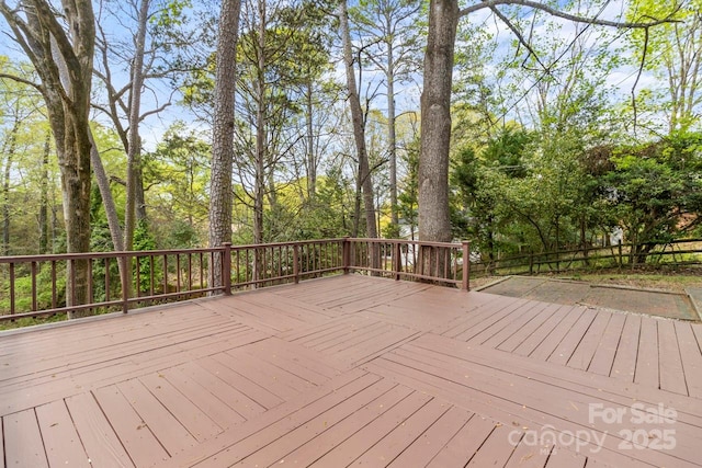 wooden deck with view of scattered trees