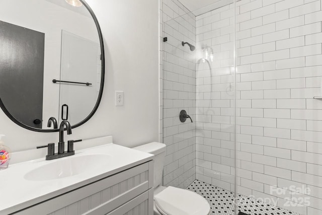 full bath featuring a shower stall, toilet, and vanity