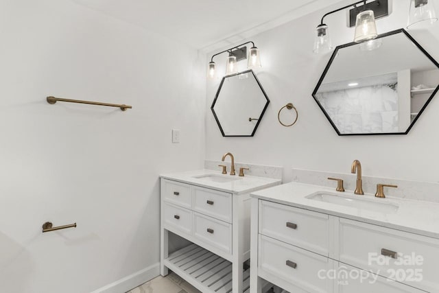 full bathroom featuring two vanities, marble look tile flooring, and baseboards