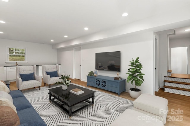 living room with light wood-type flooring and recessed lighting
