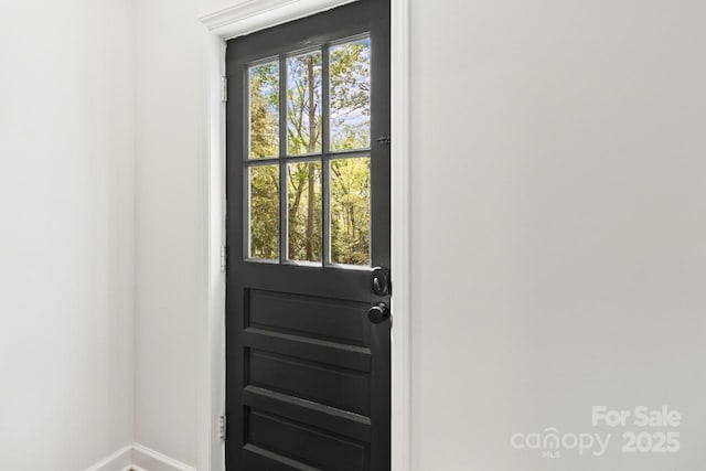 entryway featuring baseboards