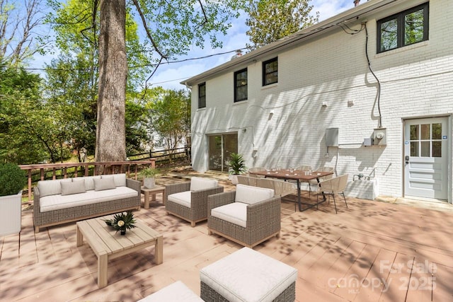 view of patio featuring outdoor lounge area, a deck, and outdoor dining area