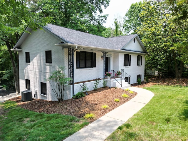 6614 Old Providence Rd, Charlotte, NC 28226 - single story home with brick siding, central air condition unit, roof with shingles, a front lawn, and covered porch