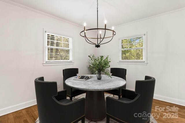 6614 Old Providence Rd, Charlotte, NC 28226 - dining area with a chandelier, wood finished floors, baseboards, and crown molding