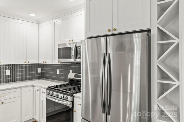 6614 Old Providence Rd, Charlotte, NC 28226 - kitchen with appliances with stainless steel finishes, white cabinetry, light stone counters, backsplash, and recessed lighting