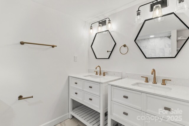 6614 Old Providence Rd, Charlotte, NC 28226 - bathroom with two vanities, marble look tiles, and baseboards
