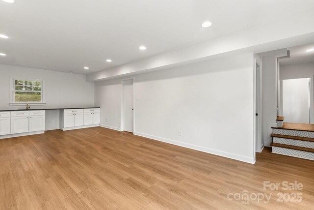 6614 Old Providence Rd, Charlotte, NC 28226 - basement featuring light wood-style flooring, baseboards, recessed lighting, and a sink