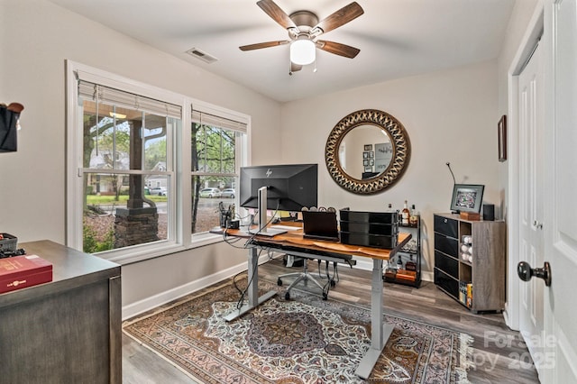 office area featuring visible vents, baseboards, a ceiling fan, and wood finished floors
