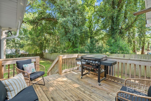 deck featuring a fenced backyard and a grill