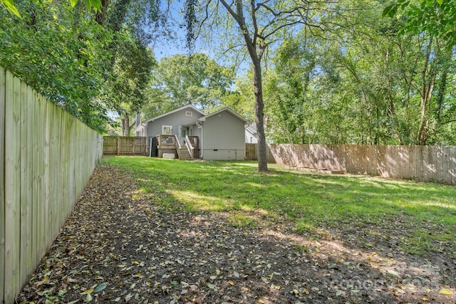 view of yard featuring a fenced backyard and a deck
