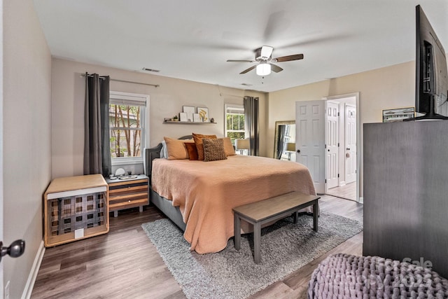 bedroom featuring visible vents, a ceiling fan, and wood finished floors