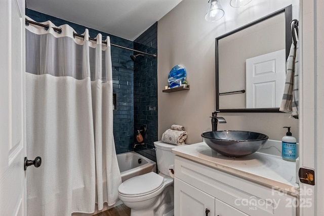 full bathroom featuring toilet, shower / bathtub combination with curtain, vanity, and wood finished floors