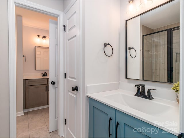 full bathroom featuring tile patterned floors, vanity, and tiled shower