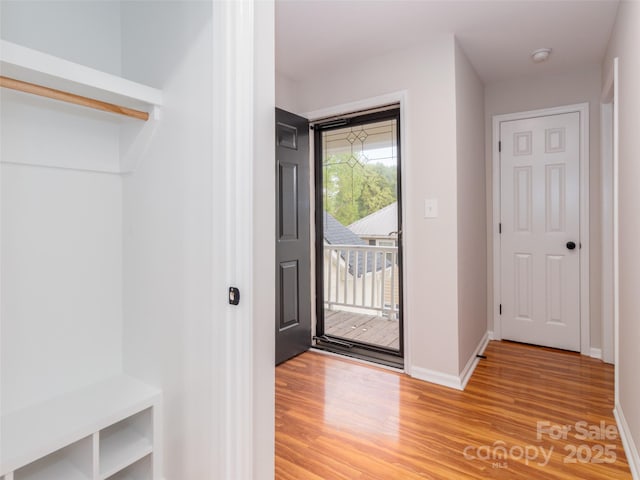 foyer featuring light wood-style flooring and baseboards