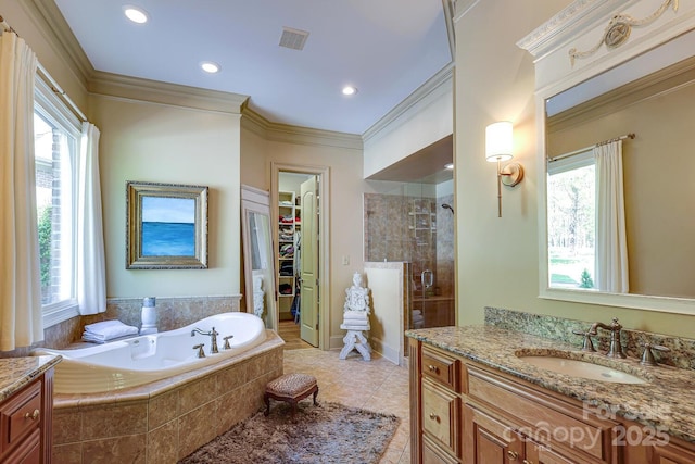 full bathroom featuring a healthy amount of sunlight, a walk in closet, a stall shower, and a garden tub