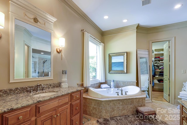 bathroom with vanity, a walk in closet, a stall shower, and visible vents