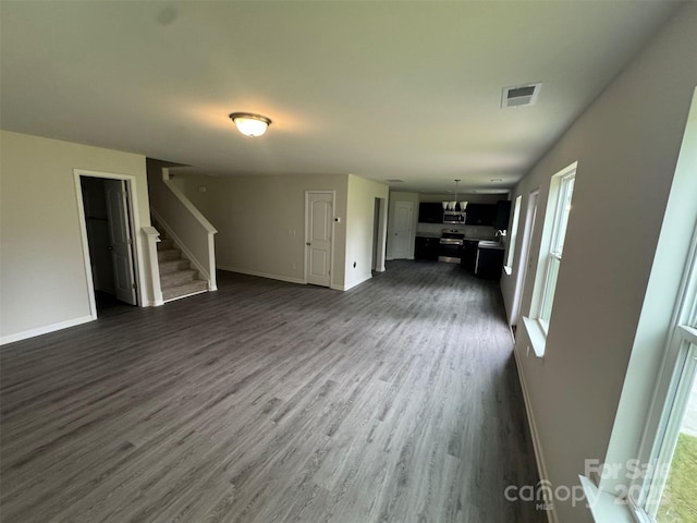 436 Phifer Rd, Kings Mountain, NC 28086 - unfurnished living room featuring stairs, dark wood-style floors, and plenty of natural light
