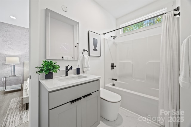 full bathroom with toilet, shower / bath combo with shower curtain, and vanity