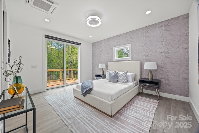bedroom with recessed lighting, baseboards, access to exterior, visible vents, and wood finished floors