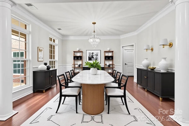 9506 Minnie Lemmond Ln Unit 170, Mint Hill, NC 28227 - dining space with wood finished floors, a chandelier, crown molding, decorative columns, and a wainscoted wall