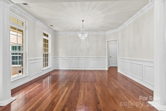 9506 Minnie Lemmond Ln Unit 170, Mint Hill, NC 28227 - unfurnished dining area featuring ornate columns, a chandelier, wainscoting, wood finished floors, and ornamental molding