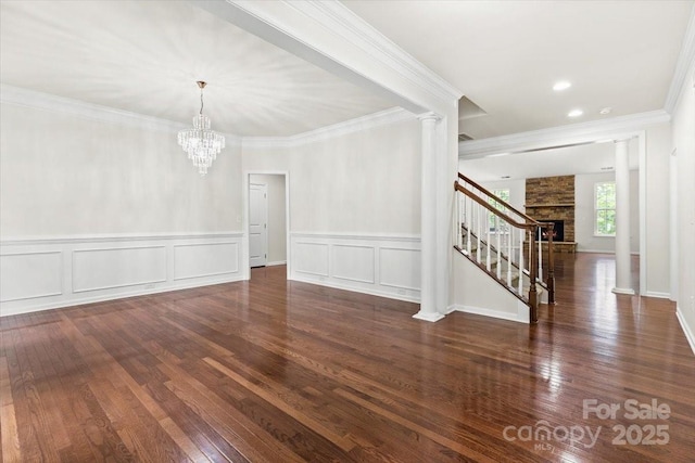 9506 Minnie Lemmond Ln Unit 170, Mint Hill, NC 28227 - unfurnished dining area featuring decorative columns, hardwood / wood-style floors, stairway, crown molding, and a chandelier