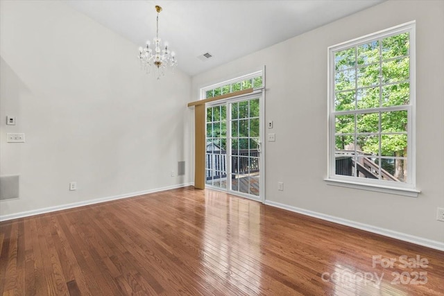 9506 Minnie Lemmond Ln Unit 170, Mint Hill, NC 28227 - empty room featuring a chandelier, wood finished floors, baseboards, and vaulted ceiling