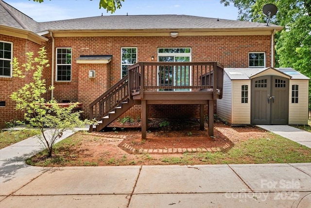 9506 Minnie Lemmond Ln Unit 170, Mint Hill, NC 28227 - back of house featuring brick siding, a deck, an outbuilding, roof with shingles, and stairs