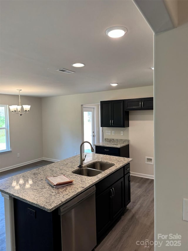438 Phifer Rd, Kings Mountain, NC 28086 - kitchen with stainless steel dishwasher, dark wood-style floors, dark cabinetry, light stone countertops, and a center island with sink