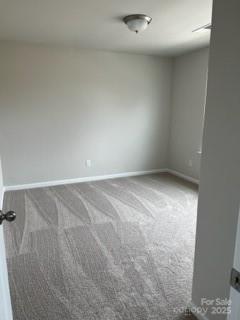438 Phifer Rd, Kings Mountain, NC 28086 - empty room with carpet floors and baseboards