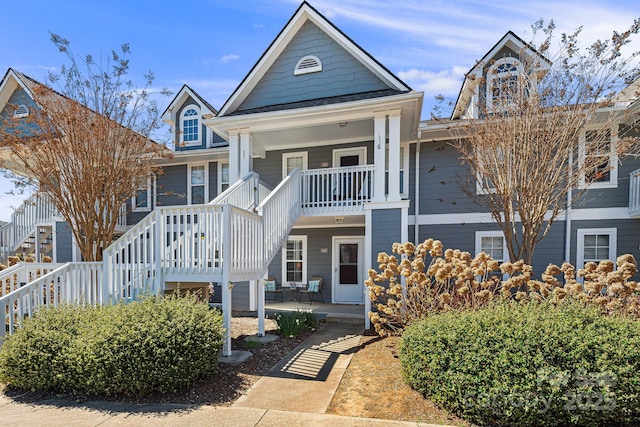 view of front facade featuring stairs and covered porch