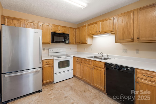 kitchen with black appliances, light countertops, a sink, and a textured ceiling