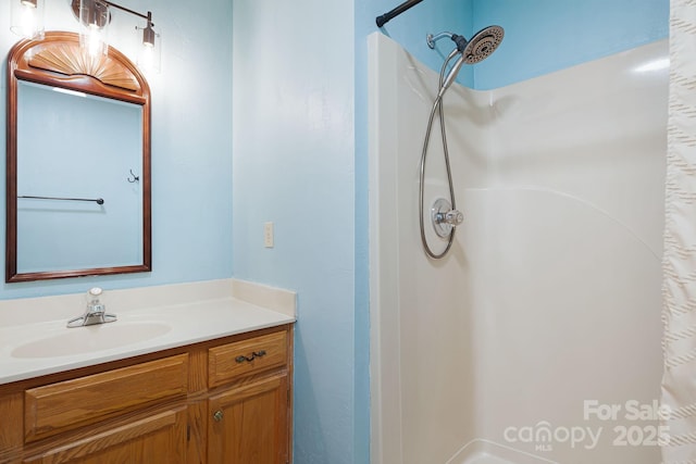 full bath featuring a shower and vanity