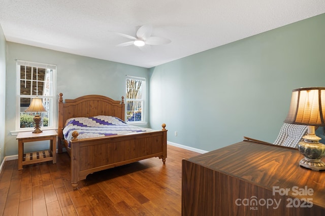 bedroom with baseboards, a textured ceiling, ceiling fan, and hardwood / wood-style flooring