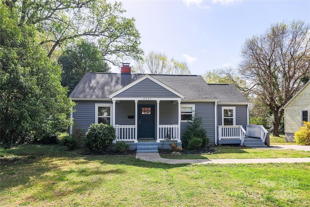 2741 Cowles Rd, Charlotte, NC 28208 - bungalow-style home with a front yard, a porch, a shingled roof, and a chimney