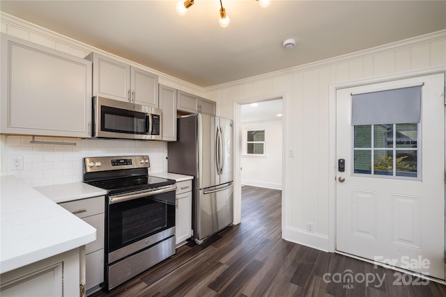 2741 Cowles Rd, Charlotte, NC 28208 - kitchen with dark wood-style flooring, crown molding, light countertops, and stainless steel appliances