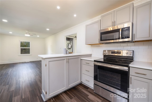 2741 Cowles Rd, Charlotte, NC 28208 - kitchen with gray cabinets, tasteful backsplash, a peninsula, and appliances with stainless steel finishes