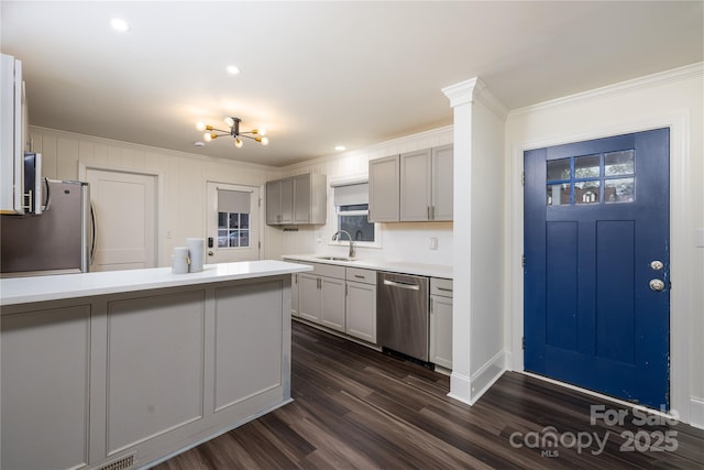 2741 Cowles Rd, Charlotte, NC 28208 - kitchen featuring light countertops, crown molding, dark wood finished floors, a sink, and appliances with stainless steel finishes