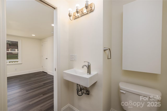 2741 Cowles Rd, Charlotte, NC 28208 - bathroom featuring baseboards, toilet, wood finished floors, recessed lighting, and a sink
