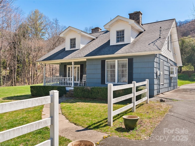 195 Nature Ln, Waynesville, NC 28786 - cape cod house with roof with shingles, fence, a front lawn, covered porch, and a chimney