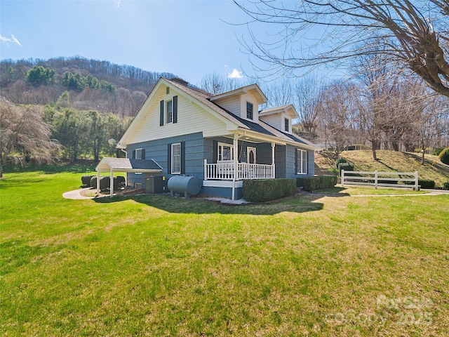195 Nature Ln, Waynesville, NC 28786 - view of side of property with covered porch, central air condition unit, heating fuel, fence, and a lawn