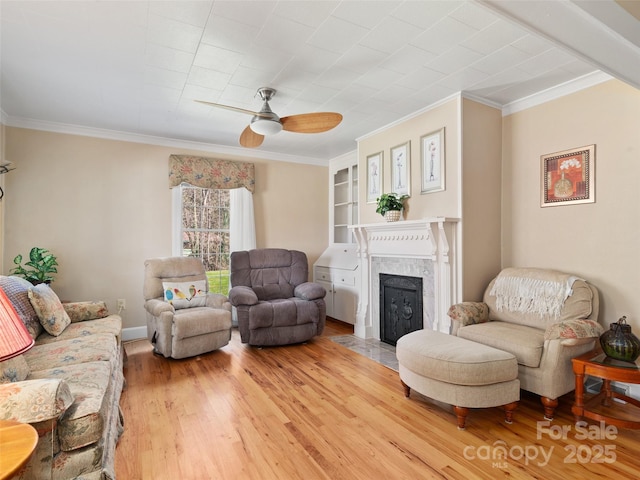 195 Nature Ln, Waynesville, NC 28786 - living room with crown molding, a fireplace, light wood-style flooring, and a ceiling fan