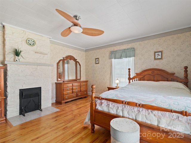 195 Nature Ln, Waynesville, NC 28786 - bedroom featuring light wood finished floors, wallpapered walls, crown molding, and a fireplace