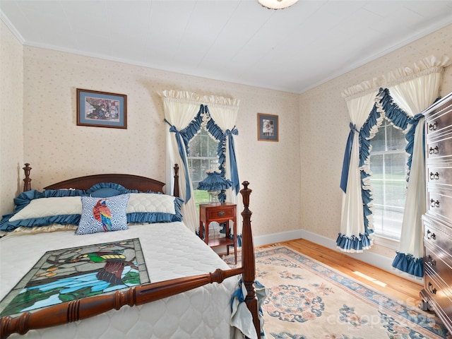 195 Nature Ln, Waynesville, NC 28786 - bedroom featuring wallpapered walls, crown molding, baseboards, and wood finished floors
