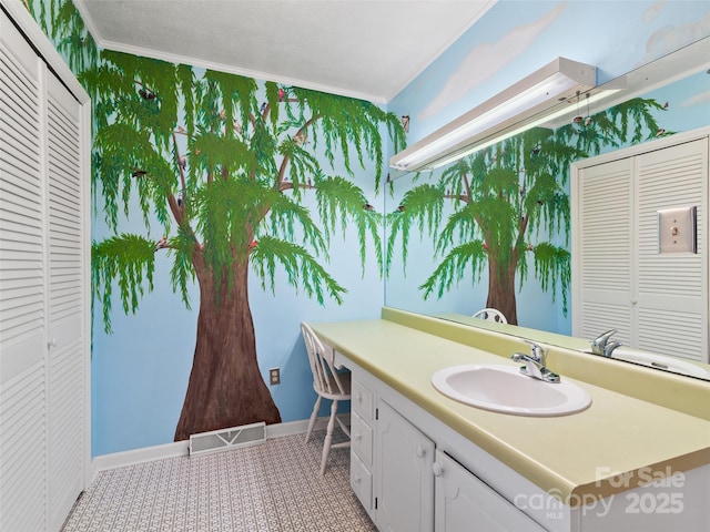 195 Nature Ln, Waynesville, NC 28786 - bathroom with a closet, visible vents, ornamental molding, wallpapered walls, and vanity