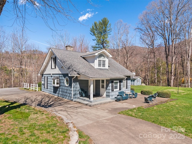 195 Nature Ln, Waynesville, NC 28786 - view of front of property with a shingled roof, a front yard, aphalt driveway, and a chimney