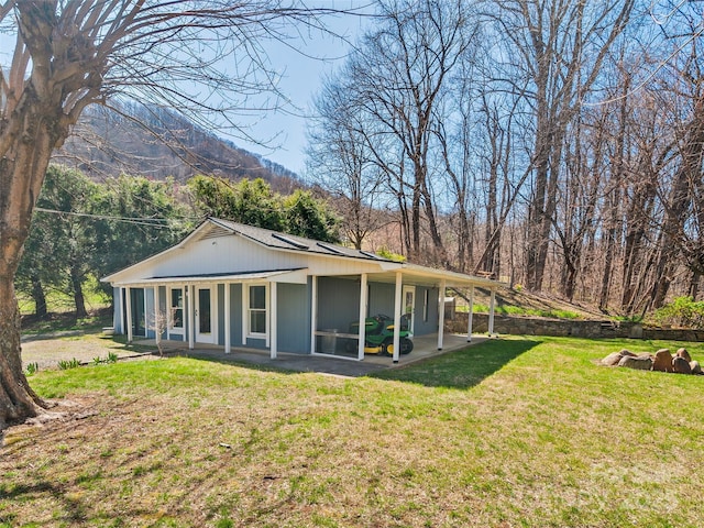 195 Nature Ln, Waynesville, NC 28786 - rear view of property featuring a lawn and solar panels